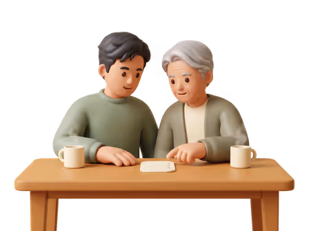 A younger adult and an older adult sit together at a table, looking at a small card with three blank lines.