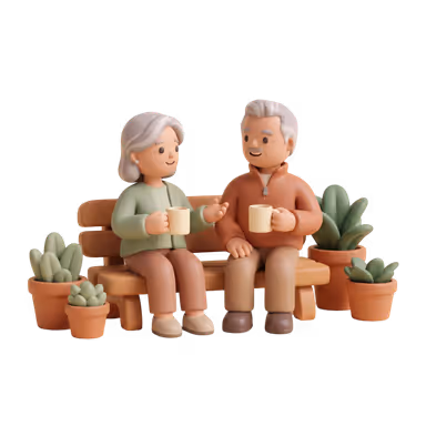 A couple sits on a garden bench with mugs, talking things over together.