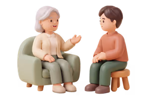 An older woman sits in an armchair talking, while a younger adult listens from a low stool beside her.